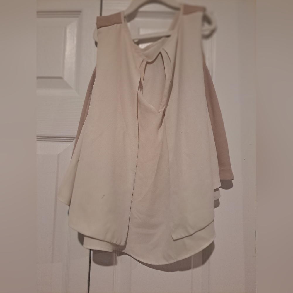 A beige blouse without sleeves